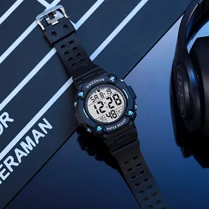 Close-up detail of a men's black multifunctional digital sports watch with luminous display.