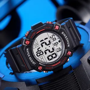 Detailed view of a multi-functional digital sports watch with black and red bezel