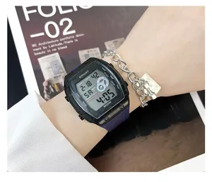 Close-up detail of a black digital sports watch with purple strap on a wrist