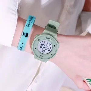 Detailed view of a light green digital sports watch with 5ATM waterproof display on wrist