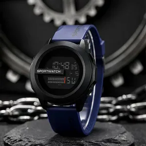 Rugged digital sports watch with black case and blue silicone strap in dark setting