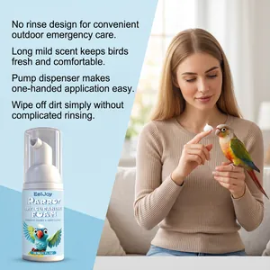EelJoy parrot dry cleaning foam showing woman applying foam to a bird on finger.