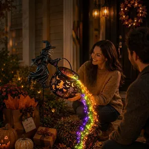 Close-up of magical Halloween witch cauldron garden light with rainbow LED lights