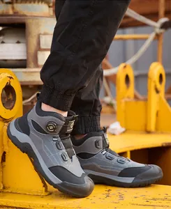 Durable grey high-top men's safety work boots with quick knob lacing in industrial site