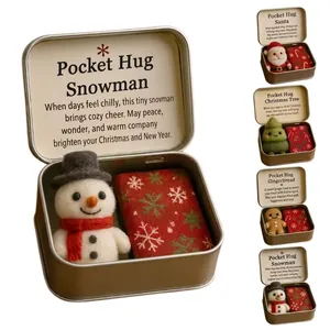 Detailed view of handmade Christmas Pocket Hug snowman figurine in a portable tin box