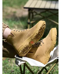 Detail view of durable tan high-top safety work boots with anti-slip soles for outdoor work