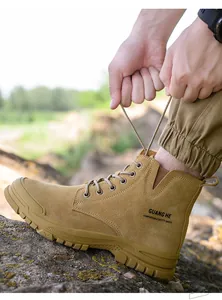 Detail view of khaki high-top steel toe safety boots being laced up outdoors.