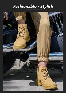 Detailed macro view of tan high-top safety work boots next to a rugged motorcycle