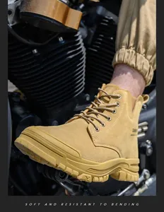 Detail of yellow high-top safety work boot showing suede texture and durable sole