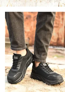 Breathable black steel-toe safety shoes for men worn outdoors with durable mesh details.