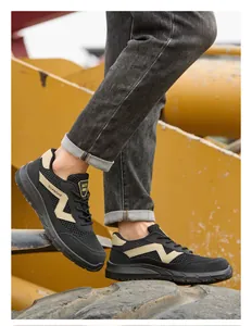 Close-up view of breathable black safety shoes with steel toe on construction site