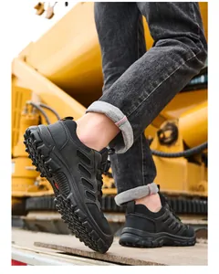 Detailed side view of black safety shoes with anti-puncture soles on a construction site.