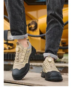 Close-up of khaki and black safety shoes with rotary knob closure being worn on site.