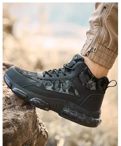 High-top men's safety work boots with camouflage pattern on outdoor rock terrain.