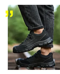 Side view of black durable safety shoes worn outdoors for work protection