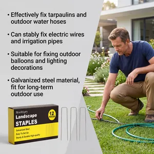 Galvanized steel landscape staples used to secure irrigation hoses on a garden lawn