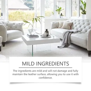 Contextual shot of mild leather care cream applied on white leather sofas in a bright room.