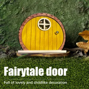 Detailed view of yellow wooden miniature fairy door for garden tree decoration.