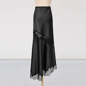 Detailed view of elegant black satin midi skirt featuring delicate lace trim and asymmetric hem