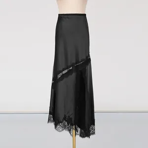 Detail view of black satin skirt featuring elegant lace trim and a high side slit.