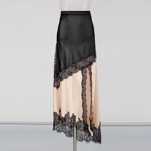 Detailed view of elegant black and champagne satin midi skirt with delicate lace trim.