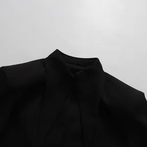 Close-up detail of the elegant black women blazer collar and structured shoulder construction