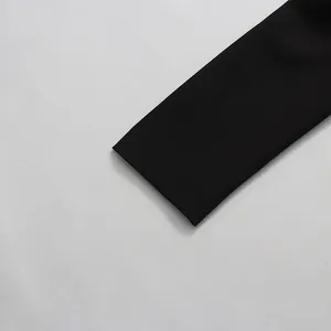 Close-up detail of high-quality smooth black fabric sleeve for elegant women's blazer