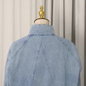 Detailed view of the back stitching and collar on a light blue denim jacket for women
