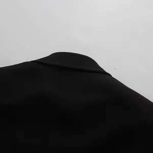 Close-up detail of the classic black blazer collar and smooth fabric texture