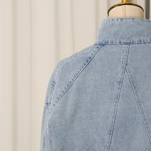Close-up back view of a light blue women's denim jacket with professional stitching