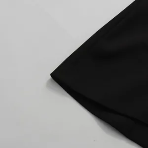 Close-up of black blazer sleeve showing high-quality fabric texture and stitching.