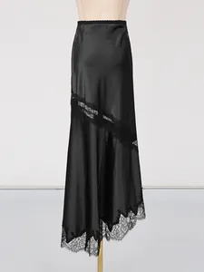 Elegant black satin midi skirt featuring delicate lace slit and an asymmetrical floral hemline