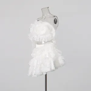 Elegant white two-piece set featuring 3D floral applique tube top and layered ruffle skirt