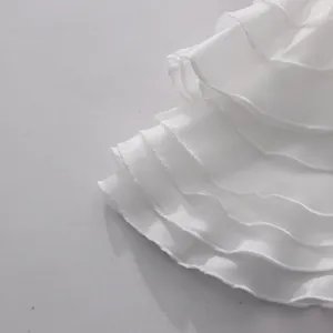 Detailed close-up showing the layered white ruffle design and delicate fabric texture