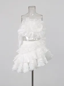 Elegant white two-piece set with floral strapless top and ruffled tiered mini skirt