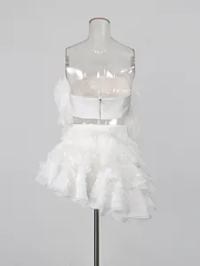 Elegant white ruffled two-piece set featuring a strapless tube top and mini skirt