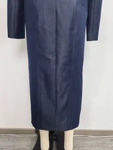 Back view detail of navy denim maxi skirt featuring structural paneled stitching.