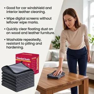 Action shot of a woman wiping a wooden table with a grey microfiber GenieCloth