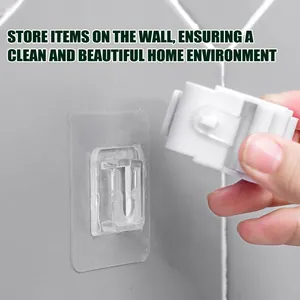 Close-up detail showing the installation of double-sided adhesive wall hooks on a wall
