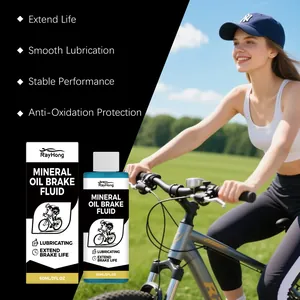 Close-up of mineral oil brake fluid bottle next to a woman riding a bicycle outdoors