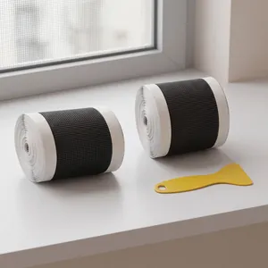 Close-up view of self-adhesive window screen repair tape rolls with yellow scraper