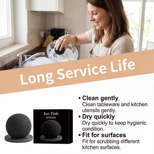 Close-up of Jue Fish black ball cleaning sponge with lifestyle kitchen usage scene