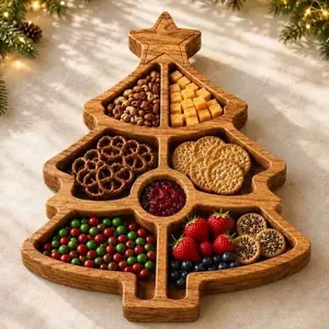 Close-up of a Christmas tree shaped wooden divided tray filled with various festive snacks