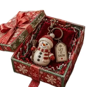 Christmas snowman keychain in red snowflake pattern gift box with festive packaging.