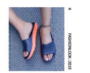 Detailed top view of navy blue and orange non-slip summer slide slippers on tiles