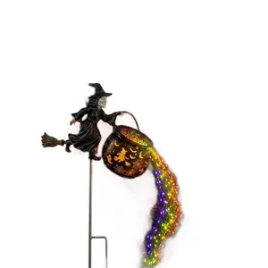 Outdoor Halloween witch garden stake light with colorful LED flowing from cauldron detail view