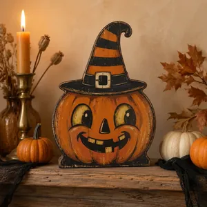 Detail view of a wooden Halloween pumpkin character with a witch hat on a table