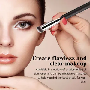 Detail view of a makeup brush blending concealer on skin for a flawless natural finish.