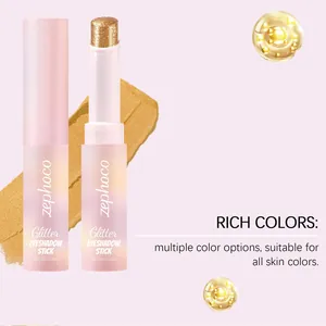 Detailed macro view of gold glitter eyeshadow stick with sparkling cream texture