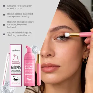 Close-up of eyelash shampoo usage with mousse bottle and cleaning brushes.